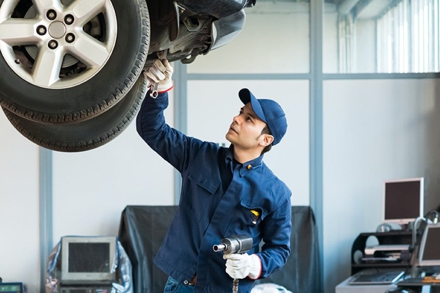 Technician inspecting tire.